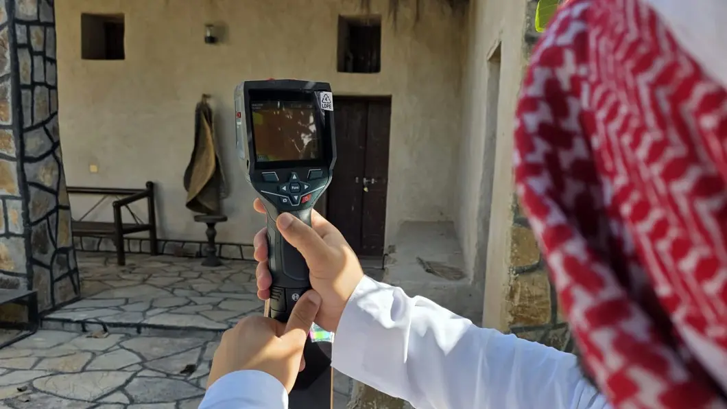 Image of a person measuring a building