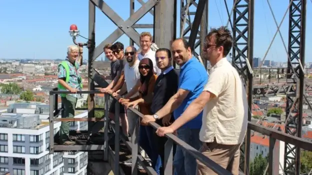 Group photo of the participants on a crane