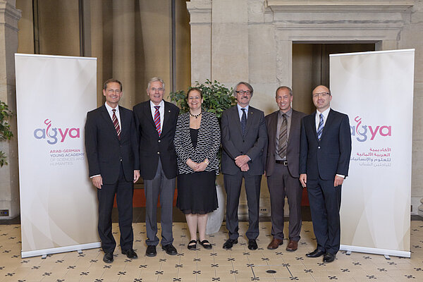 Group of people standing between two roll-up banners