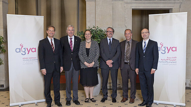 Group of people standing between two roll-up banners