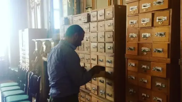Bilal Orfali searches in an archive