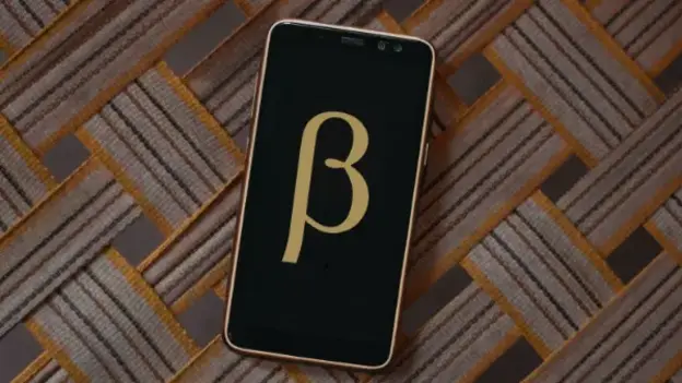 Smartphone with the letter 'ß' on display with wood structured background