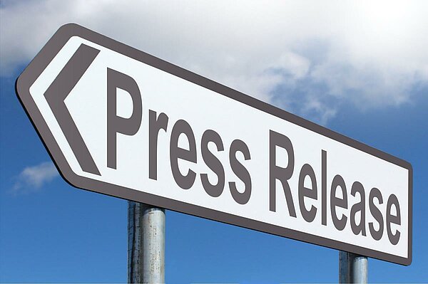 Street sign in arrow shape saying press release