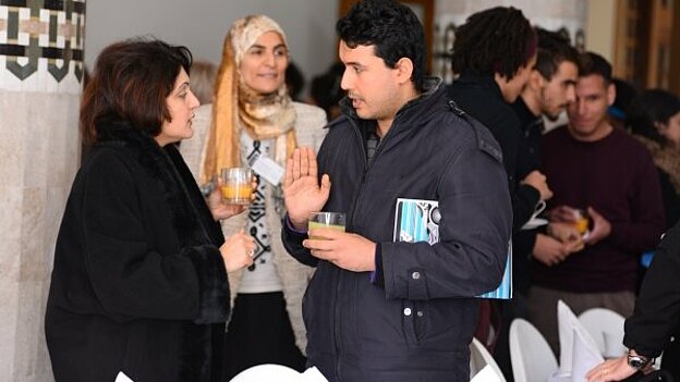 Olfa Messaoud talking to some people at the conference