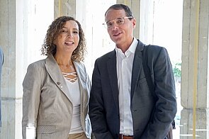 A woman and a man smiling into the camera