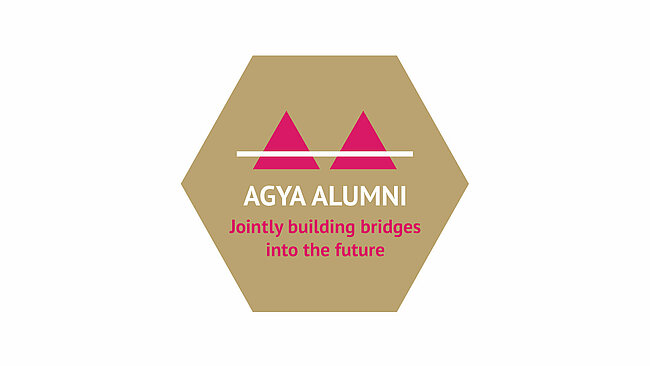 Golden Hexagon with text reading AGYA Alumni Jointly building bridges into the future