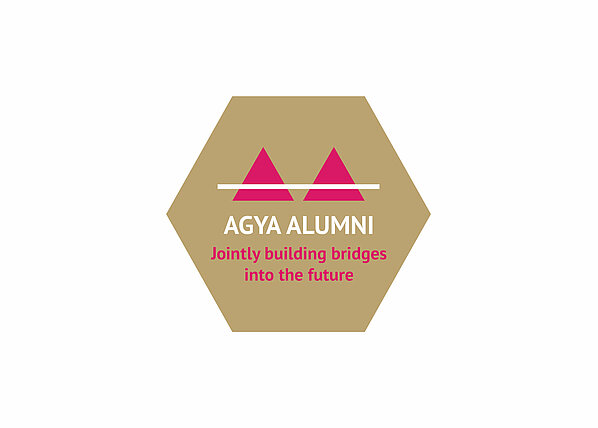 Golden Hexagon with text reading AGYA Alumni Jointly building bridges into the future
