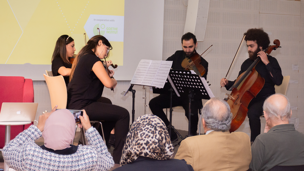 An ochestra is playing a piece by Schiffer