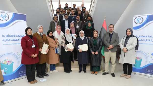 Trainees receiving their certificates, presented Dr. Noha Almagrahi, Head of the Medical Department at the Ministry of Health, and AGYA members