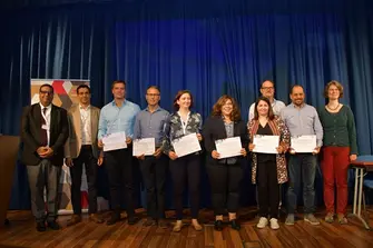 Group picture with people holding certificates in their hands