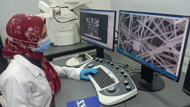 Scientist working with a lab computer