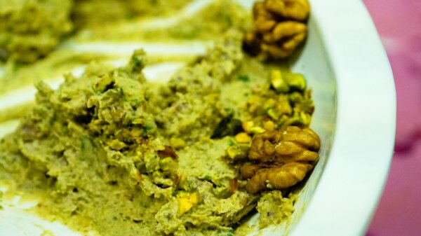 Hummus on a plate with walnuts in it